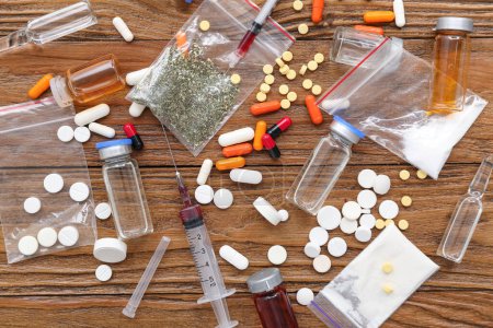 Composition with different drugs and syringes on wooden background