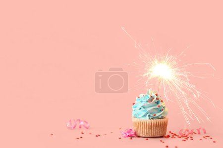 Photo for Tasty birthday cupcake with sparkler on pink background - Royalty Free Image