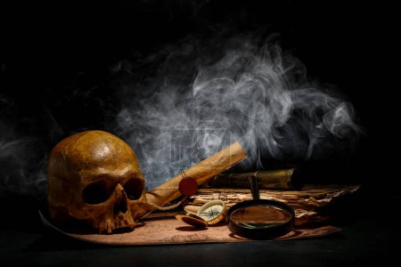 Photo for Human skull with old manuscripts, travel equipment and world map on black background - Royalty Free Image