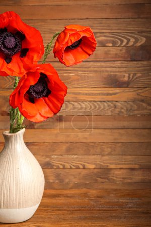 Photo for Vase with beautiful poppy flowers on wooden background - Royalty Free Image