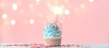 Photo for Tasty cupcake with sparkler on pink background - Royalty Free Image