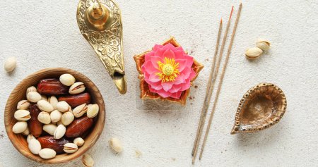 Photo for Diya lamp with lotus flower and treats for Indian holiday Diwali (Festival of lights) on light background - Royalty Free Image