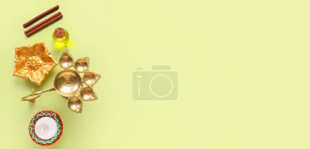 Photo for Oil lamp and candle for Indian holiday Diwali (Festival of lights) on light green background. Banner for design - Royalty Free Image