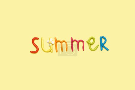 Photo for Word SUMMER made of play dough on yellow background - Royalty Free Image