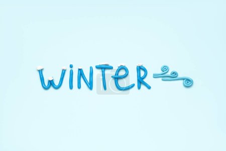 Photo for Word WINTER made of play dough on light blue background - Royalty Free Image