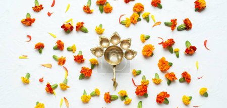 Photo for Oil lamp with marigold flowers on white background. Divaly celebration - Royalty Free Image