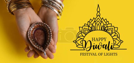 Photo for Long banner for Happy Diwali with female hands holding oil lamp - Royalty Free Image