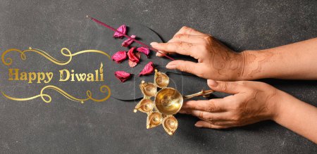 Photo for Long banner for Happy Diwali with female hands, oil lamp and aroma stick - Royalty Free Image