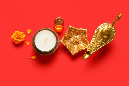 Photo for Diya lamps with candle, marigold flower and aroma oil on red background. Divaly celebration - Royalty Free Image