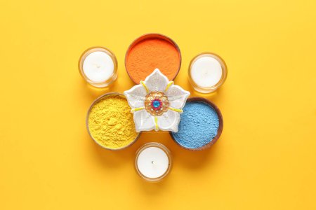 Photo for Diya lamp with candles and bowls of colorful powder on yellow background. Divaly celebration - Royalty Free Image