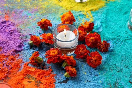 Photo for Colorful powder with candle and marigold flowers for celebration of Divaly on dark background - Royalty Free Image