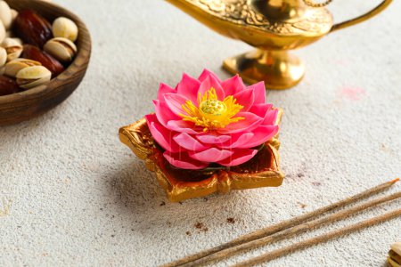 Photo for Diya lamps with incense sticks, lotus flower and bowl of treats on grunge white background. Divaly celebration - Royalty Free Image