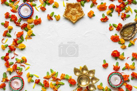 Photo for Frame made of diya lamps, burning candles and marigold flowers on white background. Divaly celebration - Royalty Free Image