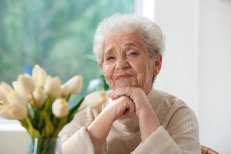 Portrait of senior woman in kitchen, closeup