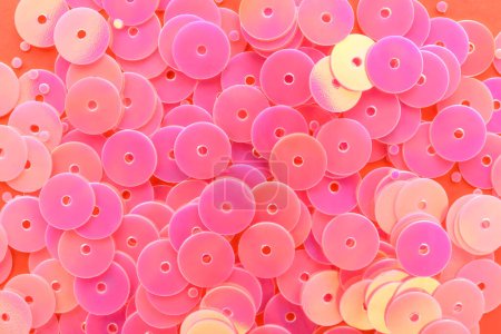 Photo for Heap of pink sequins on coral background - Royalty Free Image
