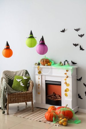 Photo for Interior of living room decorated for Halloween with fireplace and armchair - Royalty Free Image