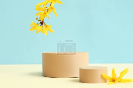 Photo for Decorative podiums and beautiful flowers on blue background - Royalty Free Image