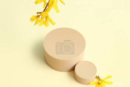 Photo for Decorative podiums and beautiful flowers on light background - Royalty Free Image