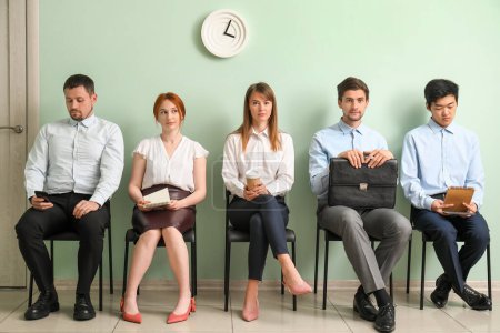 Photo for Young applicants waiting for job interview in room - Royalty Free Image