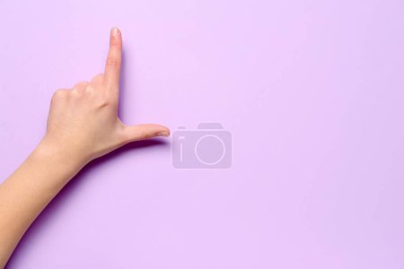 Photo for Woman showing loser gesture on lilac background - Royalty Free Image