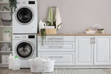 Photo for Laundry room with washing machines and white counters - Royalty Free Image