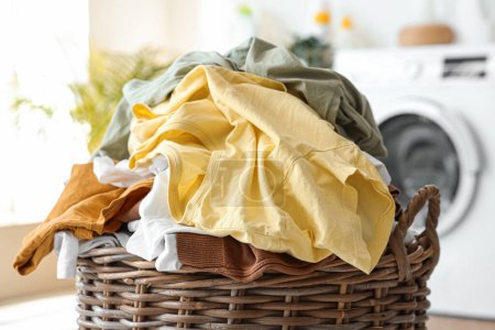 Photo for Wicker basket with dirty clothes in laundry room, closeup - Royalty Free Image
