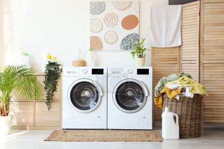 Photo for Interior of laundry room with washing machines and dirty clothes - Royalty Free Image