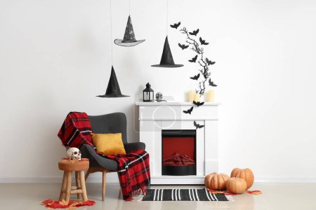 Photo for Interior of living room decorated for Halloween with fireplace and armchair - Royalty Free Image