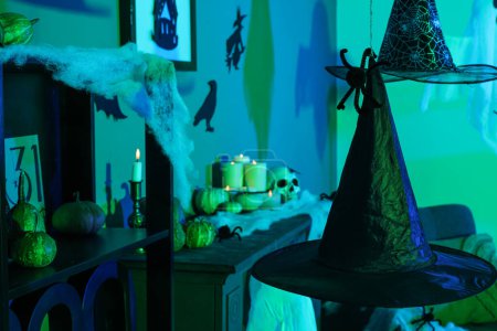 Photo for Witch hats hanging in dark room decorated for Halloween, closeup - Royalty Free Image