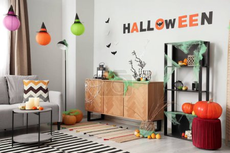 Photo for Interior of light living room decorated for Halloween with drawers and shelf unit - Royalty Free Image