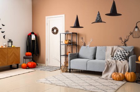 Photo for Interior of living room decorated for Halloween with sofa and vampire costume - Royalty Free Image