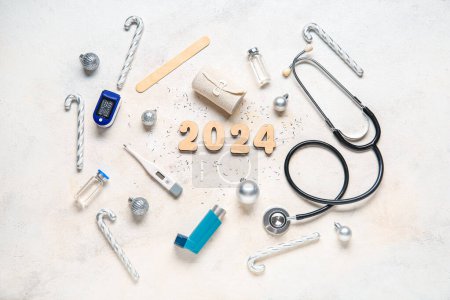 Figure 2024 and doctor's tools with Christmas decor on white background