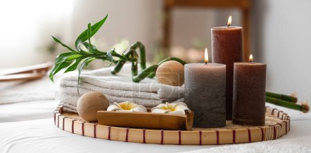 Photo for Burning candles, massage balls, towers and flowers in spa salon - Royalty Free Image