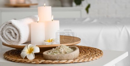 Photo for Burning candles, sea salt, towel and flowers in spa salon - Royalty Free Image