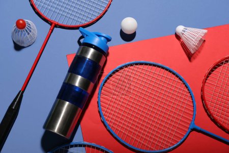 Photo for Composition with bottle of water, rackets, ball and shuttlecocks on color background - Royalty Free Image