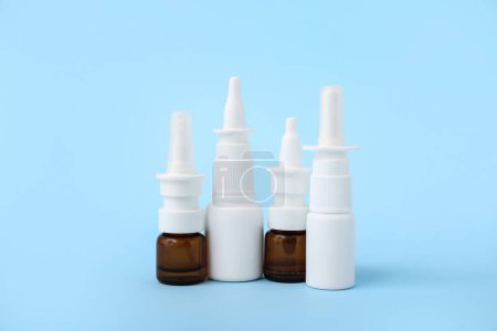 Photo for Bottles of nasal drops on blue background - Royalty Free Image
