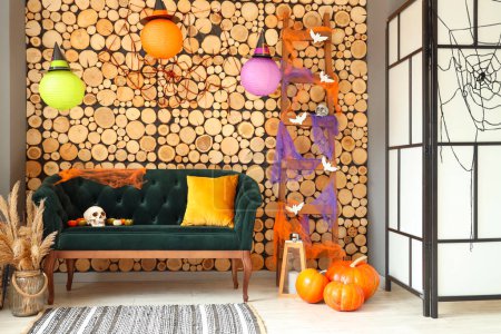 Photo for Interior of living room decorated for Halloween with green sofa and ladder - Royalty Free Image