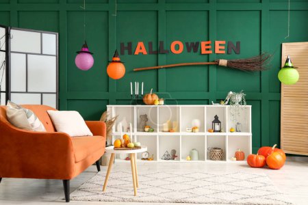 Photo for Interior of living room decorated for Halloween with red sofa and shelf unit - Royalty Free Image