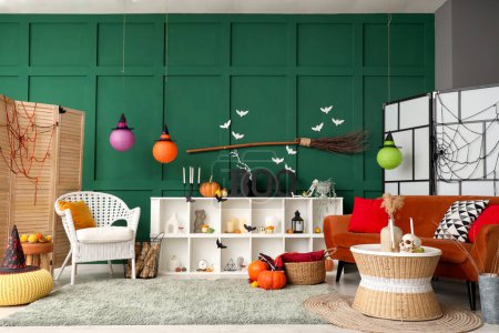 Photo for Interior of living room decorated for Halloween with red sofa and shelf unit - Royalty Free Image