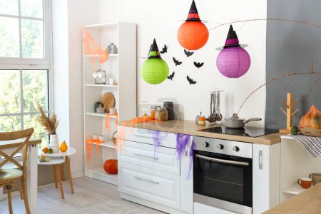 Photo for Interior of light kitchen decorated for Halloween with white counters - Royalty Free Image