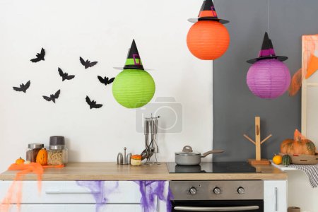 Photo for Interior of light kitchen decorated for Halloween with counters and lanterns - Royalty Free Image