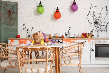 Photo for Interior of light kitchen decorated for Halloween with counters and dining table - Royalty Free Image