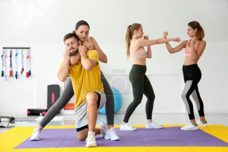 Photo for Young women training at self defense courses in gym - Royalty Free Image