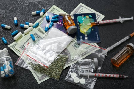 Photo for Different drugs, syringes, money and credit cards on dark background - Royalty Free Image