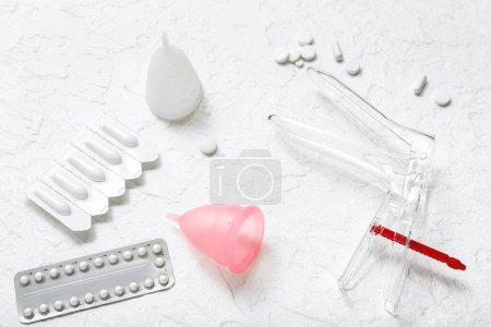 Photo for Gynecological speculum, pills, suppositories and menstrual cups on white background - Royalty Free Image
