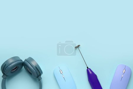 Photo for Modern headphones with computer mouses and mixer on blue background - Royalty Free Image
