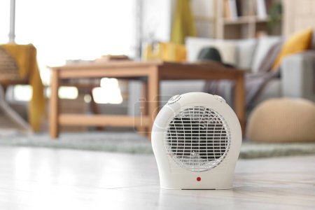 Photo for Electric fan heater on floor in living room - Royalty Free Image