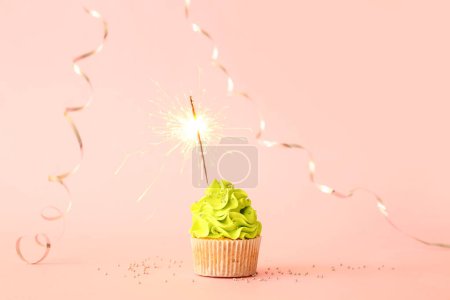 Photo for Tasty birthday cupcake with sparkler and decor on pink background - Royalty Free Image
