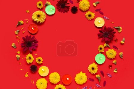 Photo for Frame made of burning candles and beautiful flowers on red background. Divaly celebration - Royalty Free Image