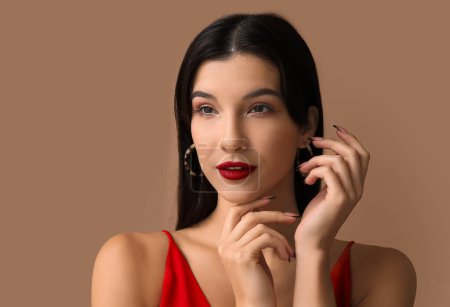 Téléchargez les photos : Belle jeune femme avec rouge à lèvres sur fond brun - en image libre de droit